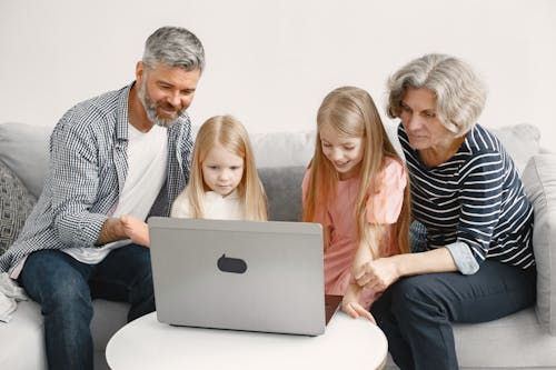 Free A Family Sitting on the Couch Stock Photo