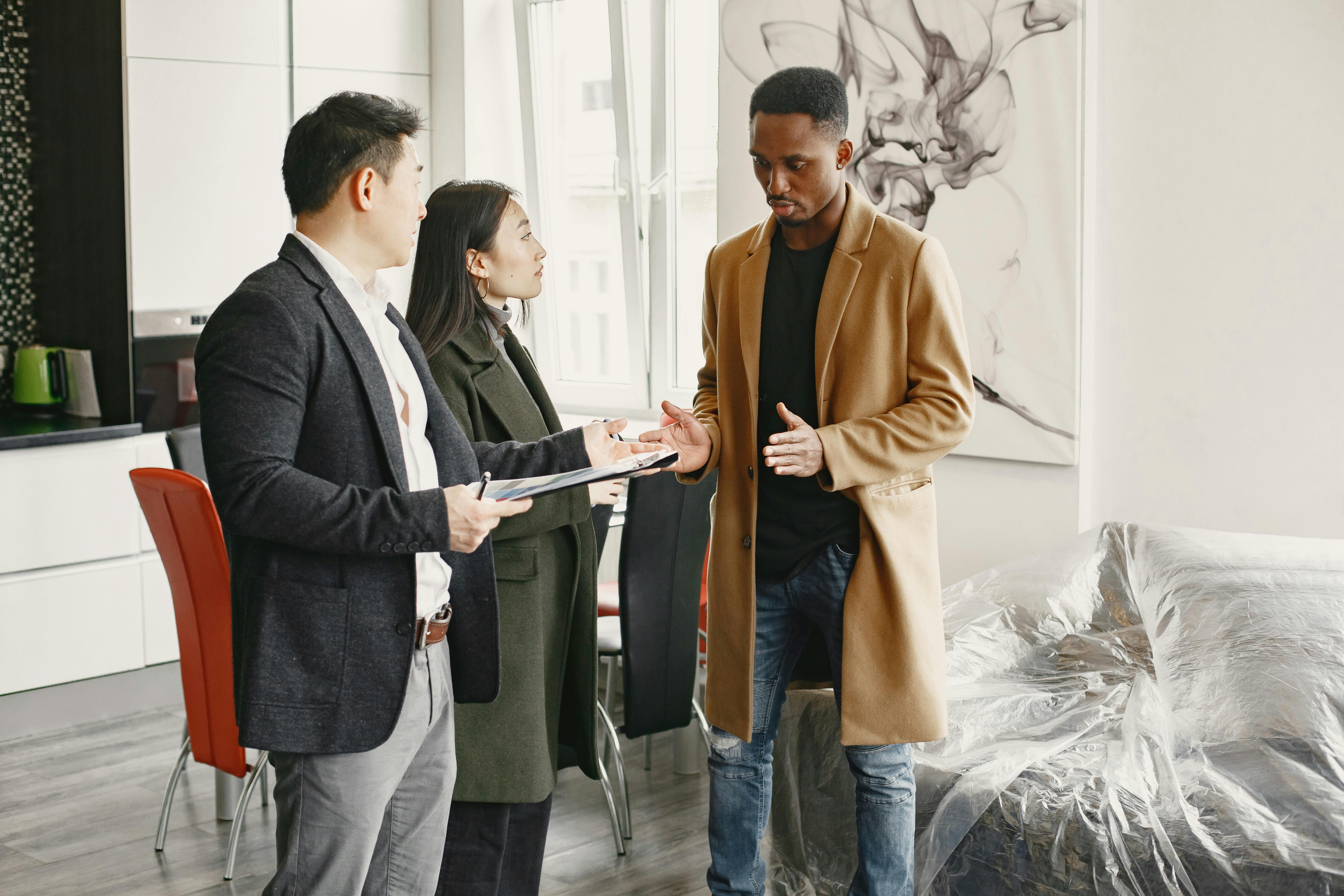 A Man in Brown Coat Explaining Something while Showing His Hands