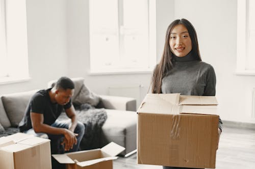 Free Woman Holding Moving Box Stock Photo