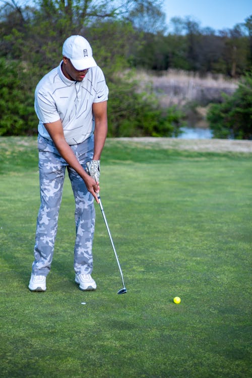 Free Man in White T-shirt and Gray Pants Playing Golf Stock Photo