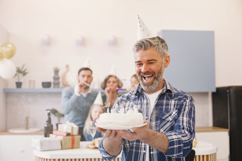 Free Man Happily Holding a Cake Stock Photo