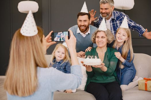 A joyful family birthday celebration captured with cake and party hats.