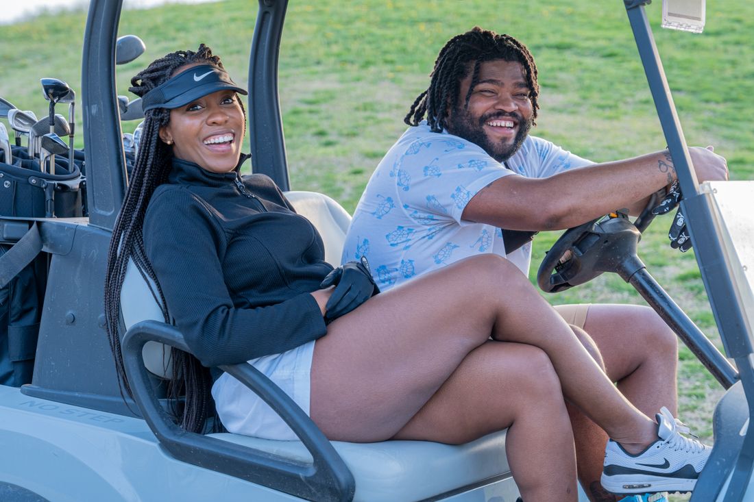 Couple sitting together on a golf cart