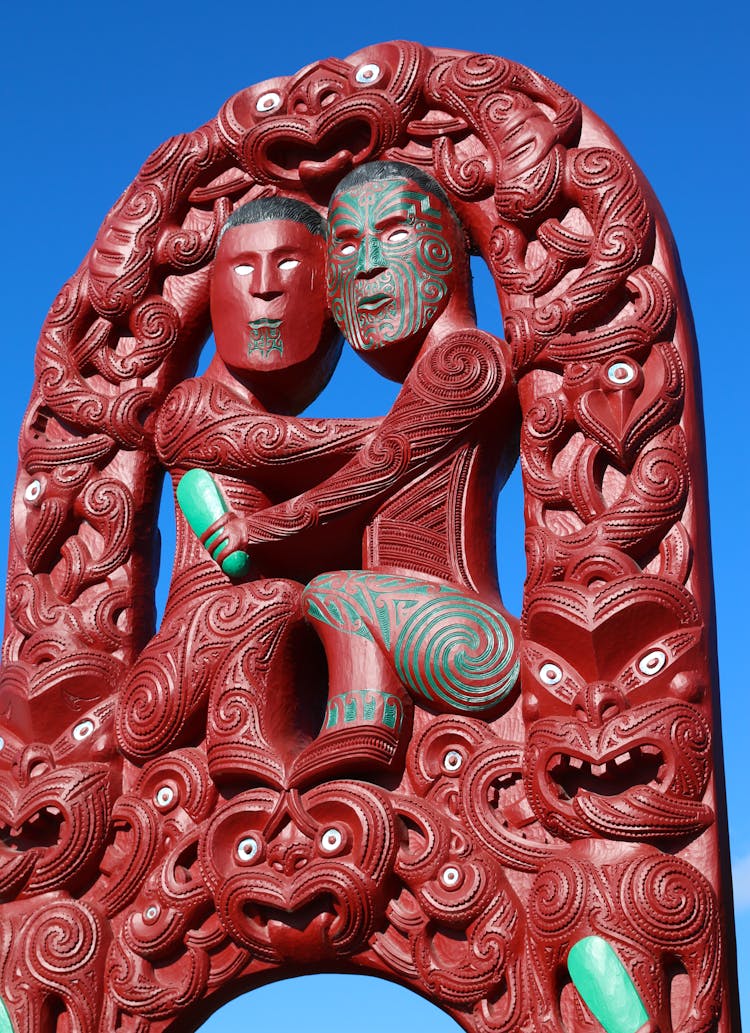 Red Maori Statue Under Blue Sky