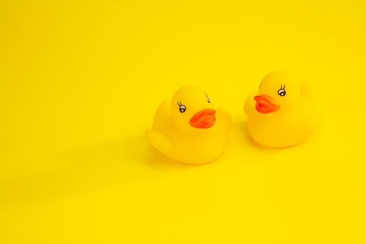 Rubber Ducks On Yellow Surface