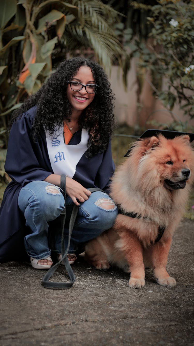 Photo Of A Woman With Curly Hair Beside Her Cute Chow Chow Pet