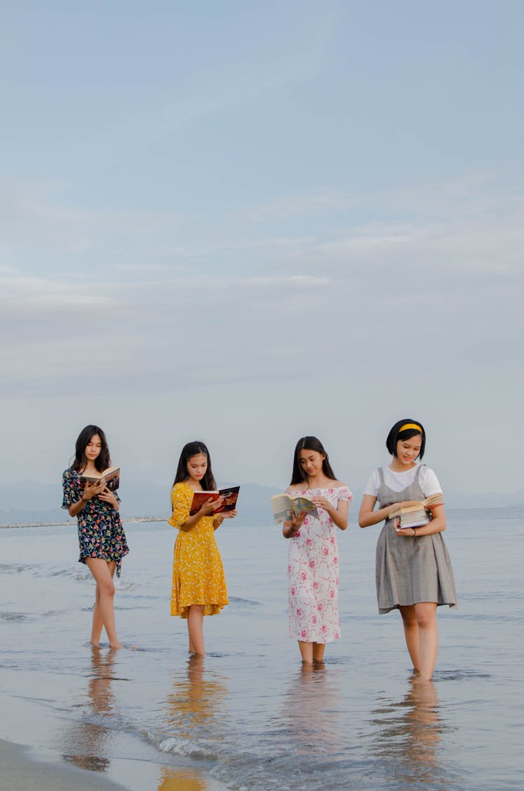 Girls Reading Books At The Beach