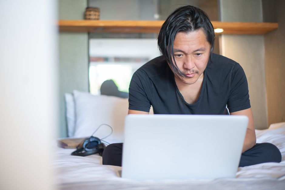 Freelancer working at home office desk with laptop