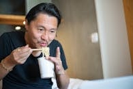 A Man Eating Noodles