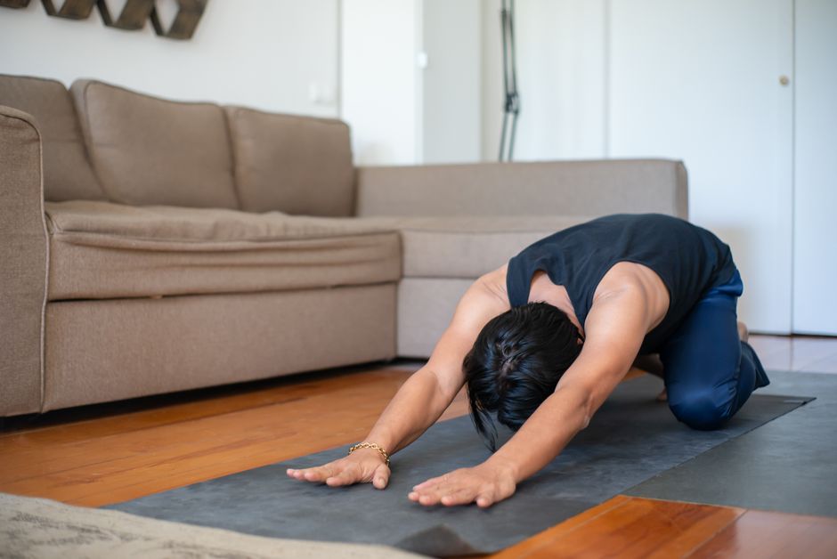 person practicing gentle stretching floor mat