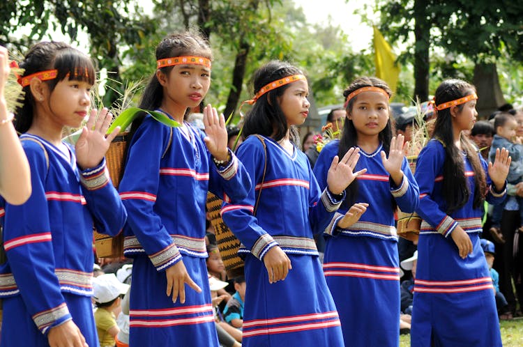 Girls With Matching Clothes Standing Together And Showing Their Palm