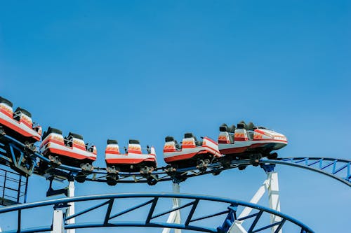 Red and White Roller Coaster on Railings