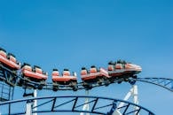 Red and White Roller Coaster on Railings