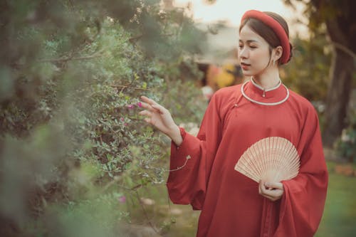 Free Woman a Red Dress Holding a Hand Fan Stock Photo