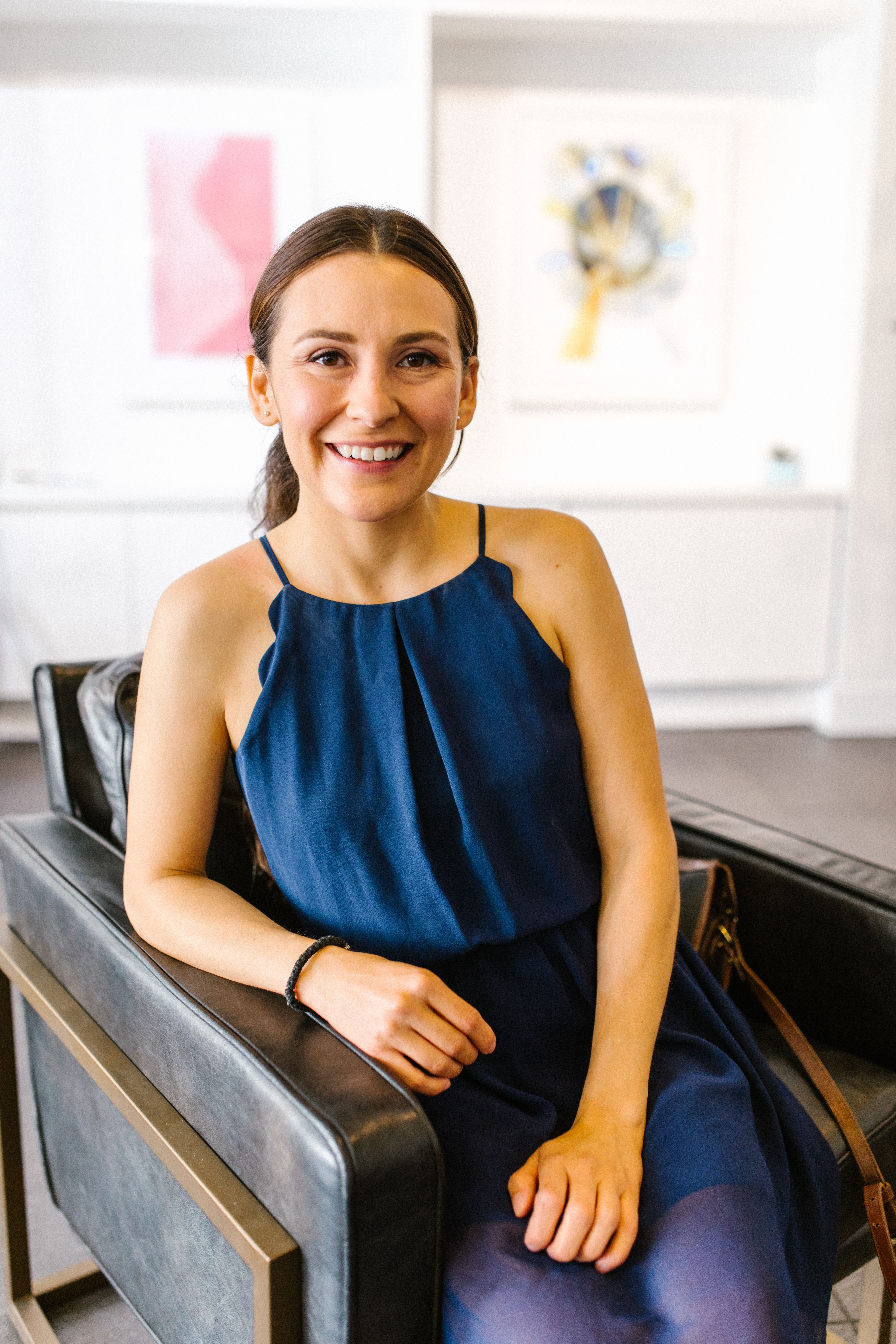 A Beautiful Woman in Blue Dress Smiling while Sitting on the Chair ...