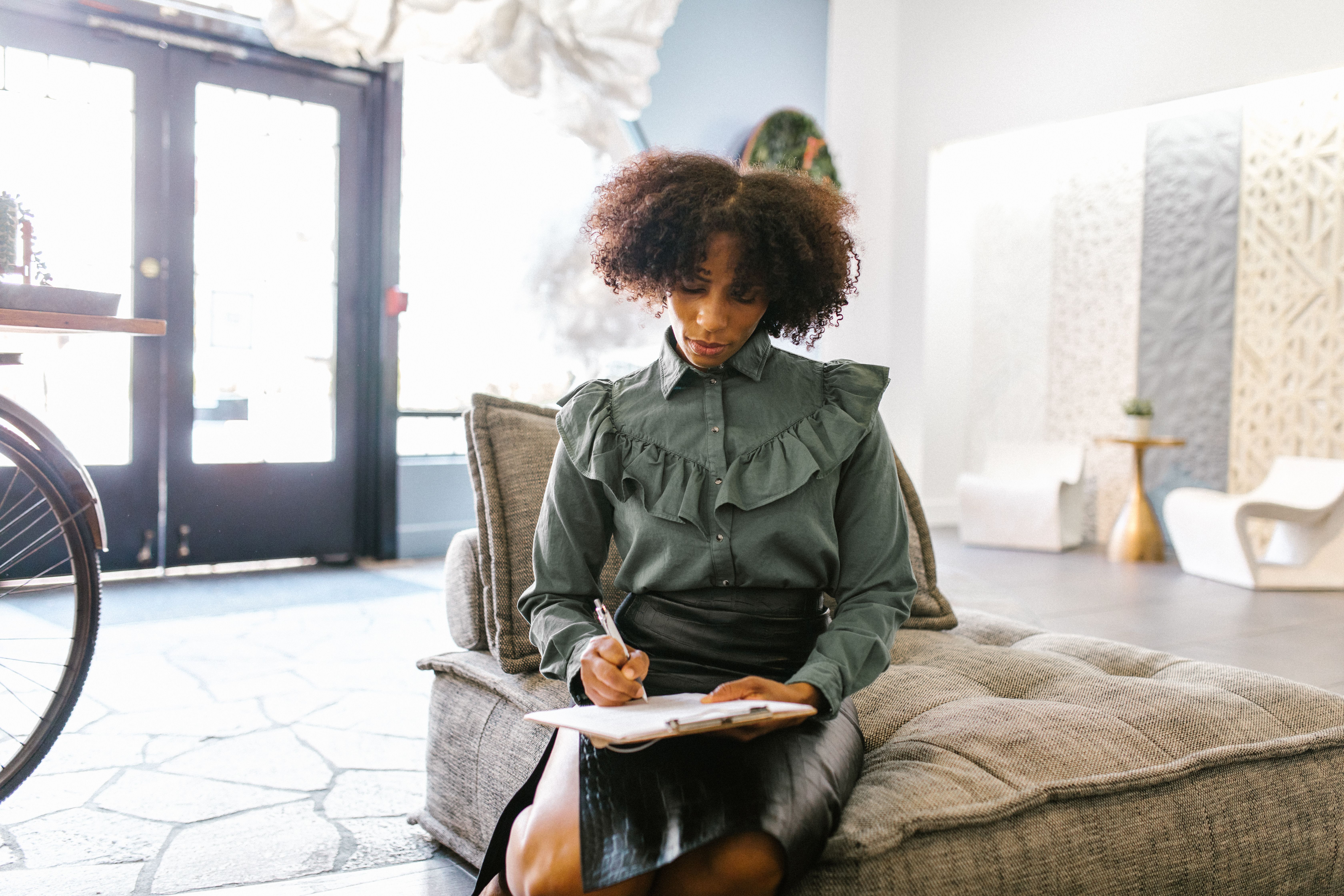 A Woman Writing on a Clipboard · Free Stock Photo