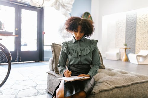 A Woman Writing on a Clipboard