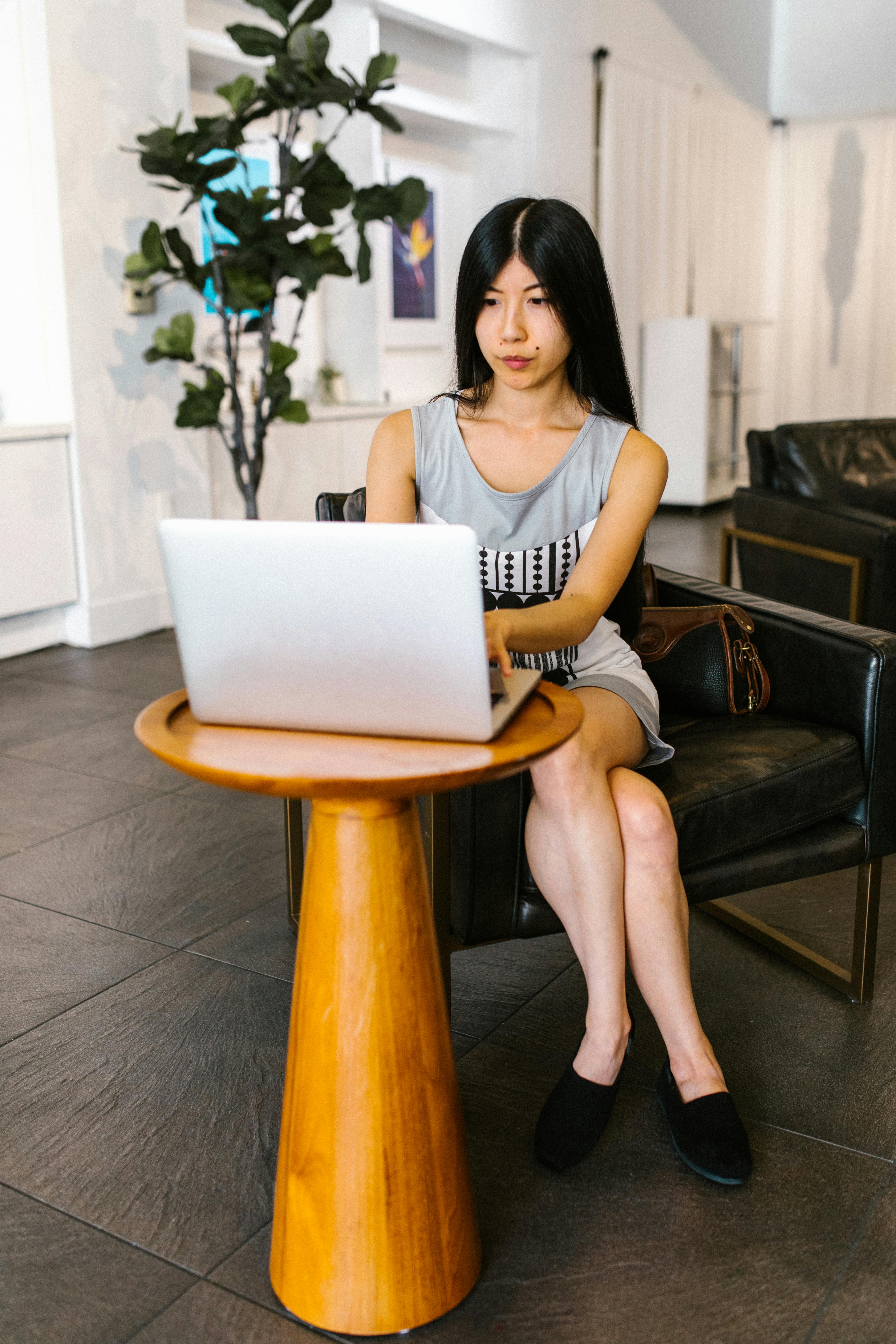 woman inside the office using a macbook