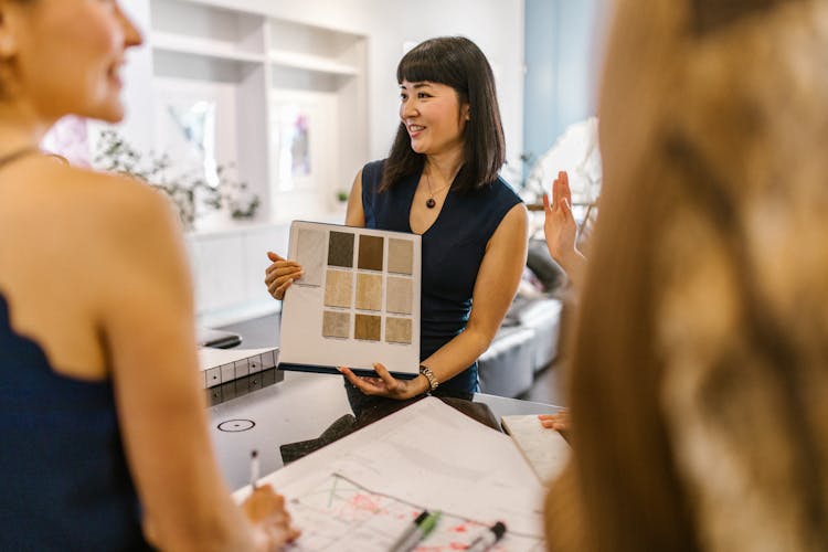 A Woman In A Blue Sleeveless Top Doing A Presentation