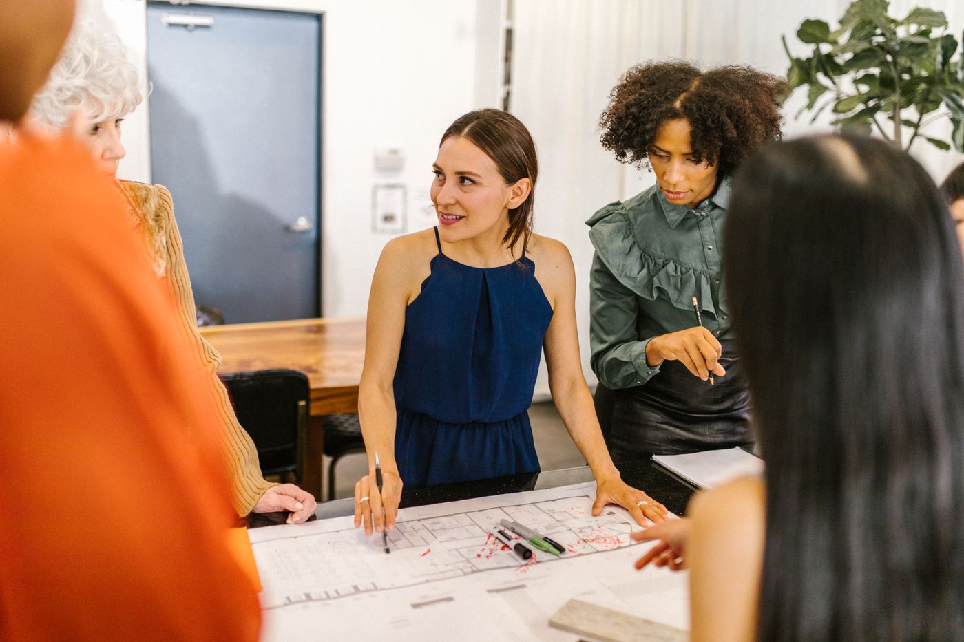 Diverse group of women collaborating in a modern business meeting
