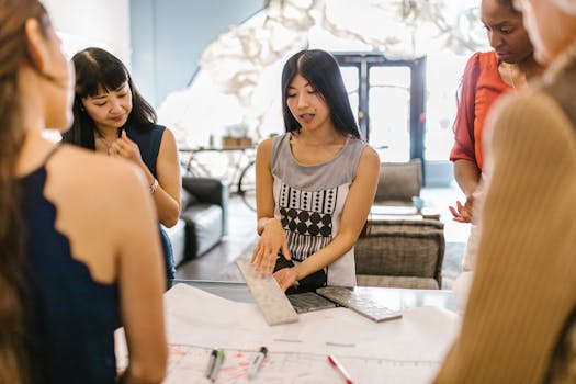 A group of women engaging in a creative discussion in a modern office setting.