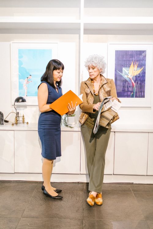 Free Two women discussing documents in a modern office setting. Stock Photo