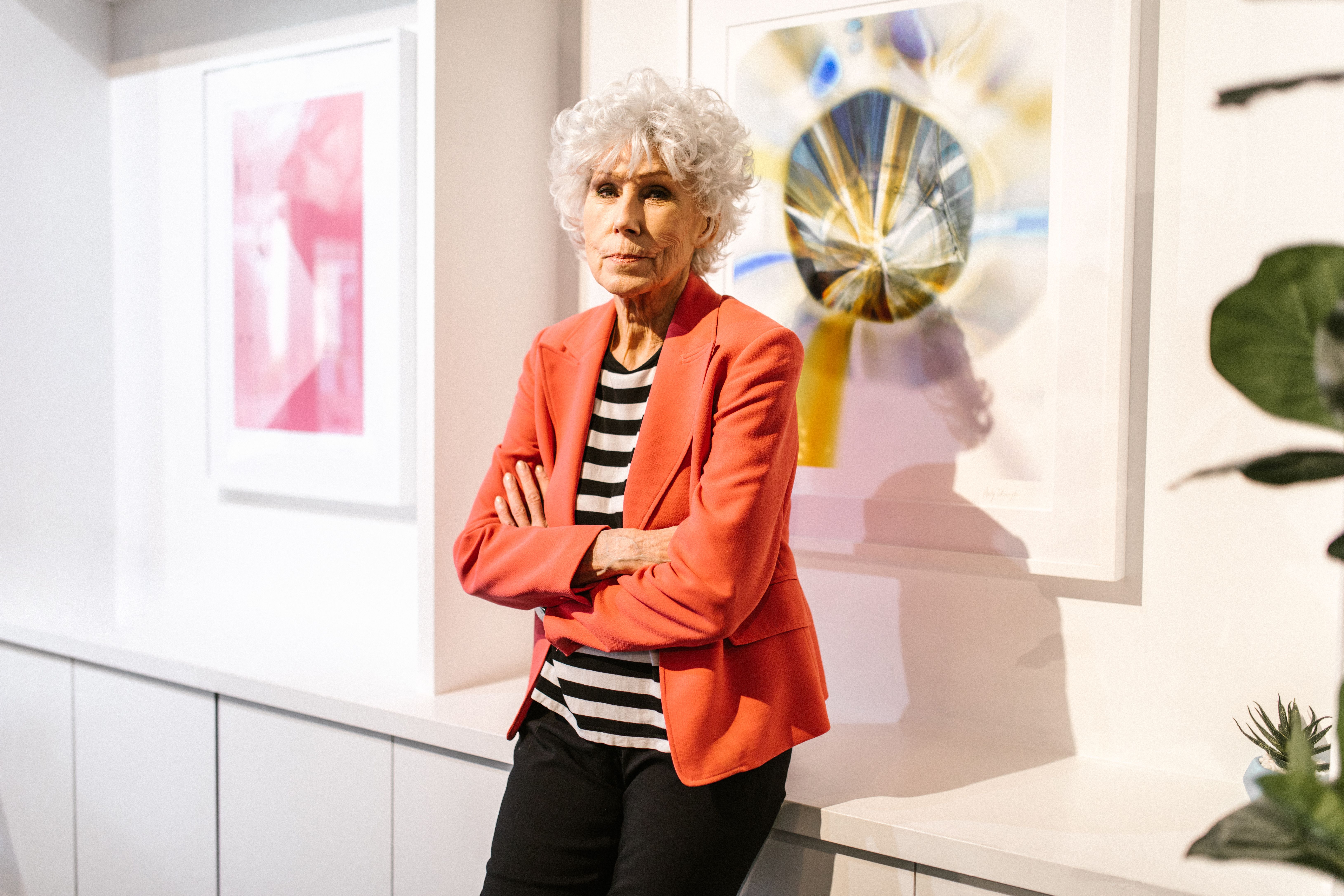 An Elderly Woman Wearing a Blazer with Her Arms Crossed · Free Stock Photo
