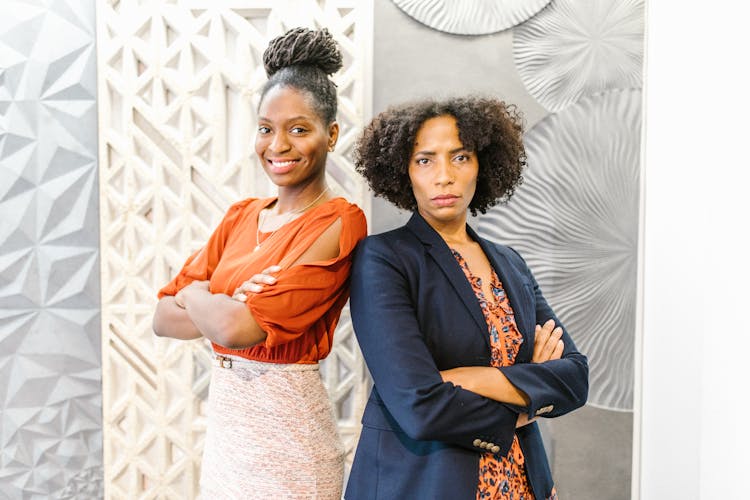 Women Standing Together With Their Arms Crossed