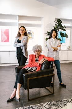 Three diverse women in a modern office setting exuding confidence and leadership.