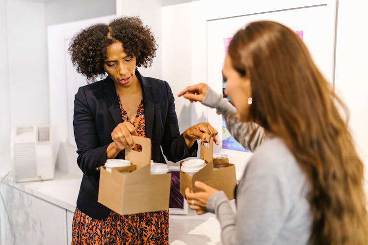 Women Holding Takeaway Coffee Cups