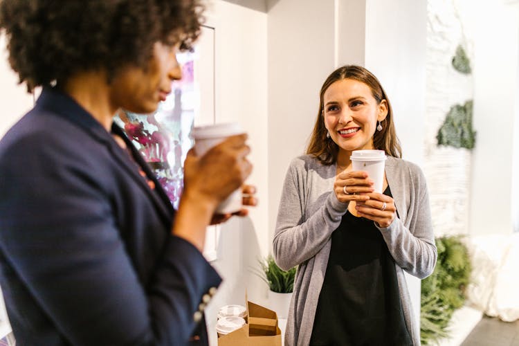 Women Holding Takeaway Coffee Cups 