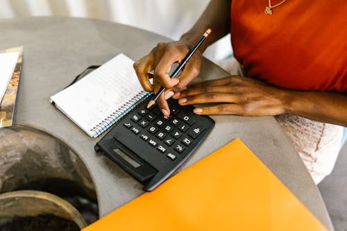 Free Woman Uses Calculator Stock Photo