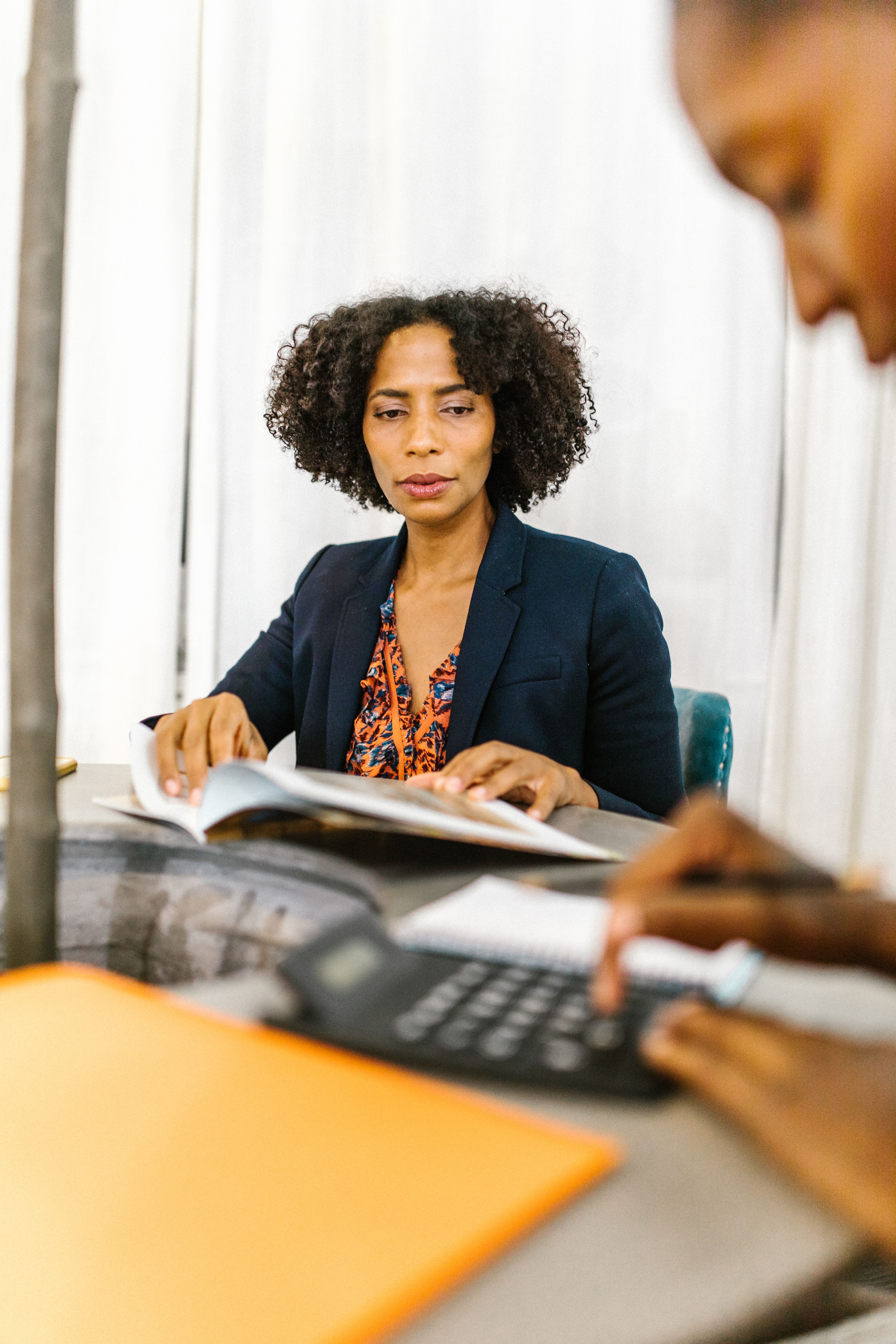 A Woman in Black Blazer Sitting on a Chair · Free Stock Photo