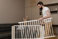 Man Setting Up a Dismantled Baby Crib