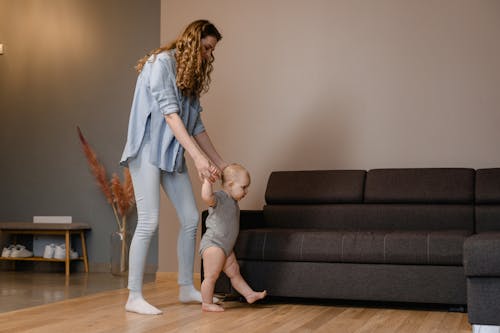 Mother Educating Baby to Walk