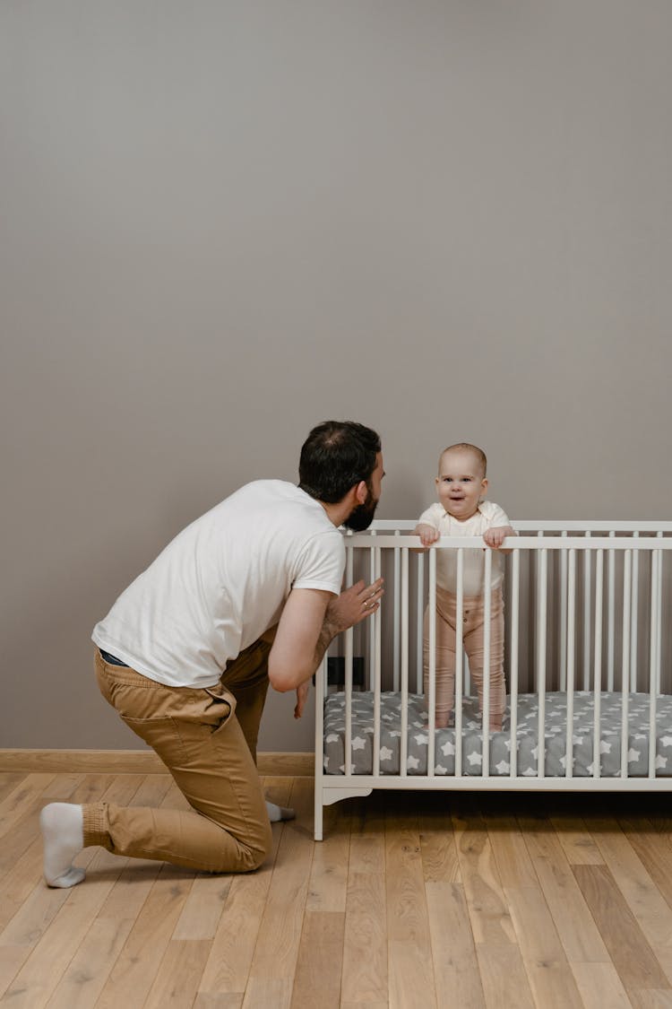 A Father With His Son In A Crib