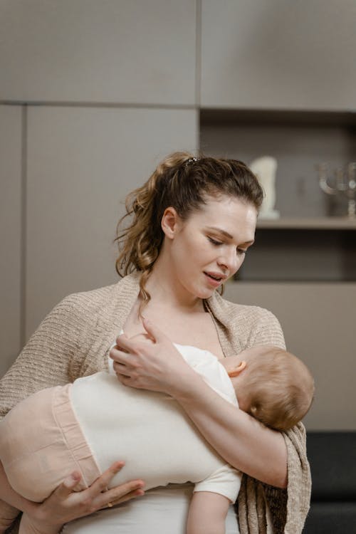 Free Mother Caressing her Baby to Sleep Stock Photo