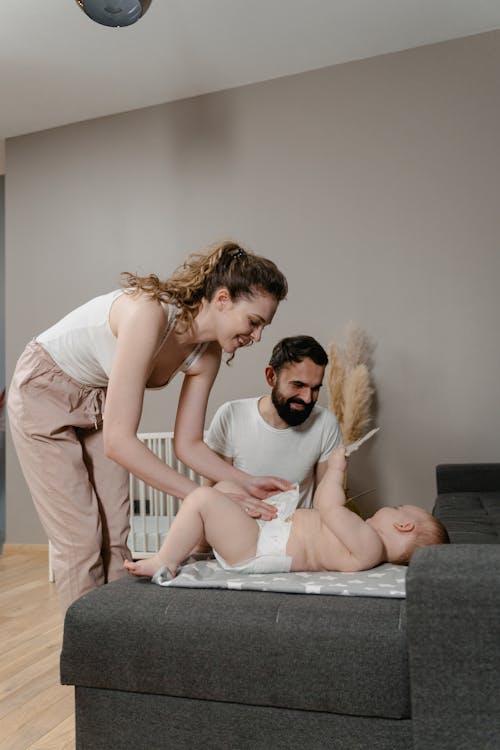 Free Mother Changing her Baby's Diaper Stock Photo