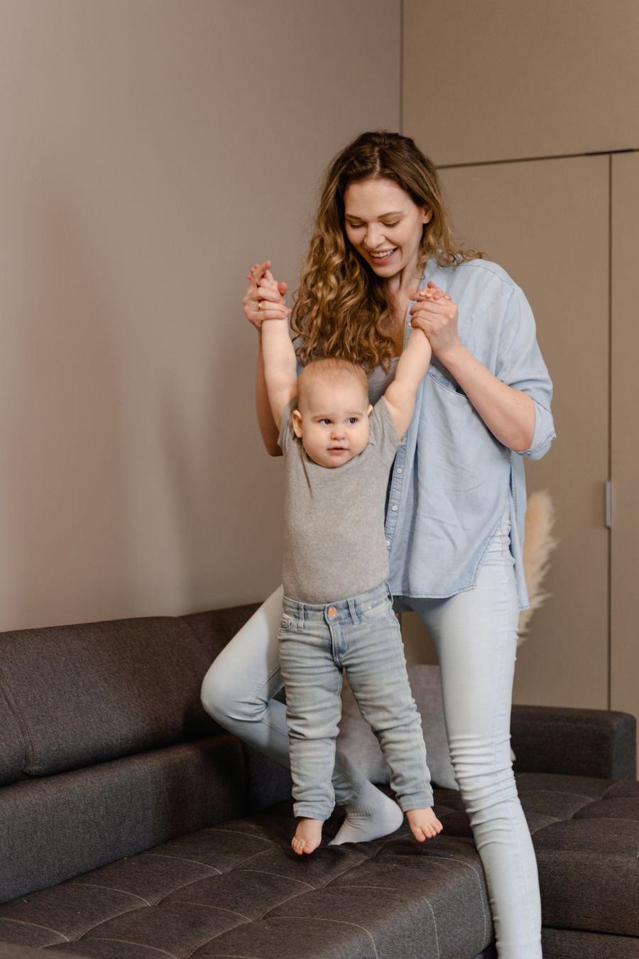 Mother playing with her baby on the living room floor