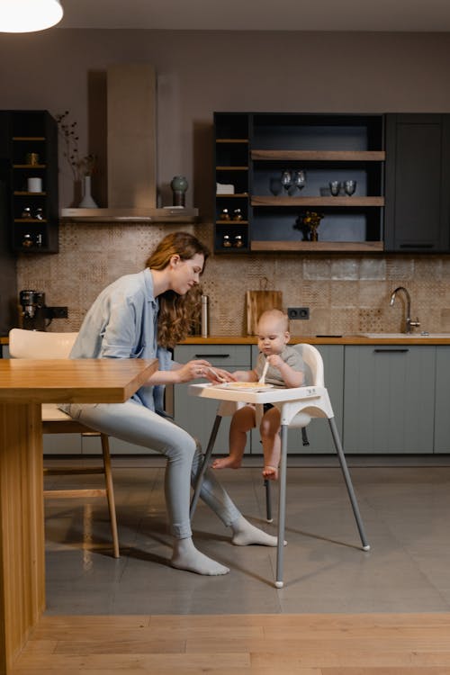 Free A Woman Feeding a Child Stock Photo