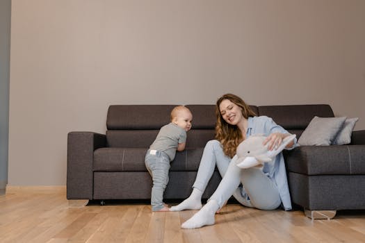 A joyful mother and her baby playing together on the living room floor, creating tender family moments.