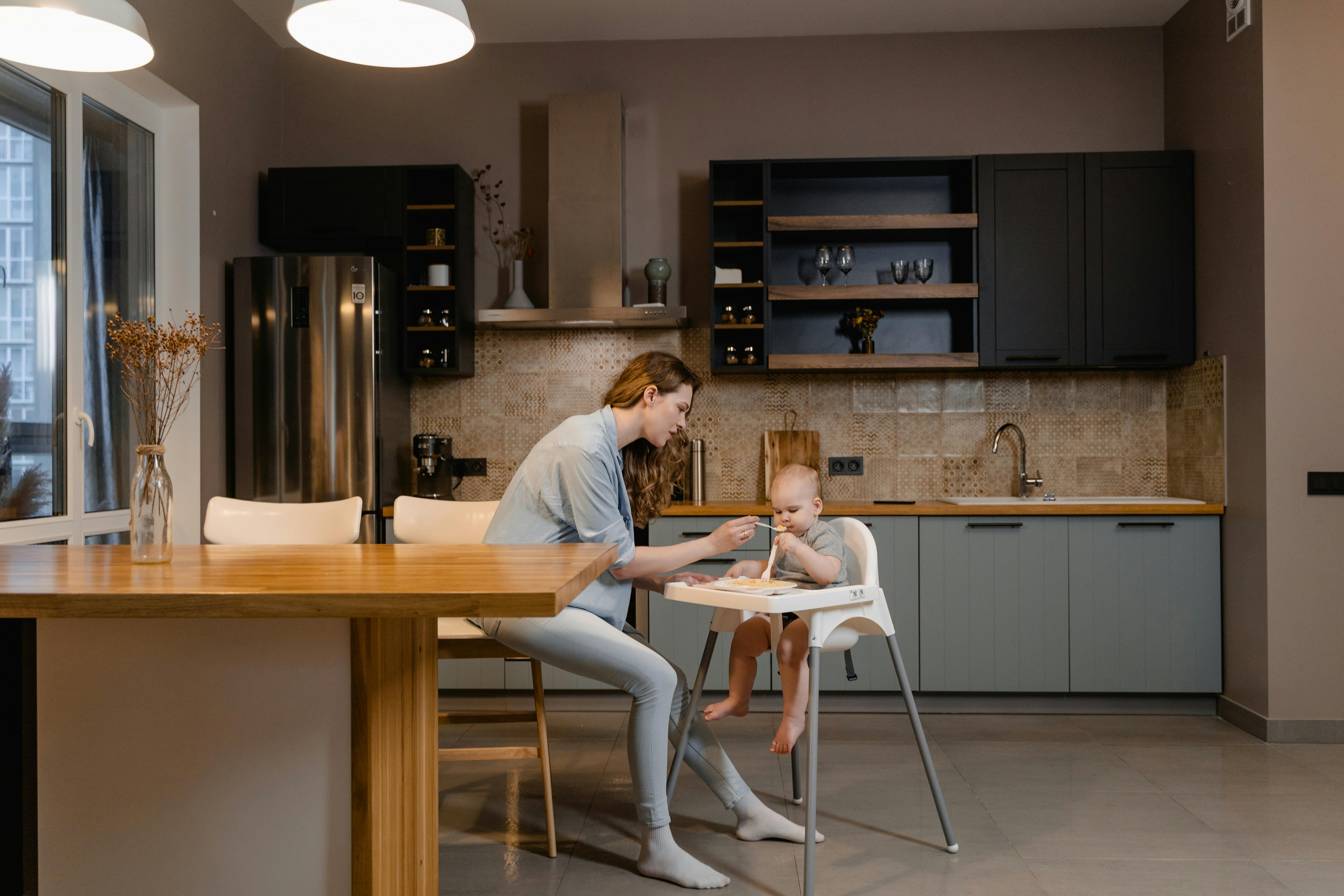 2 women sitting on chair in front of table