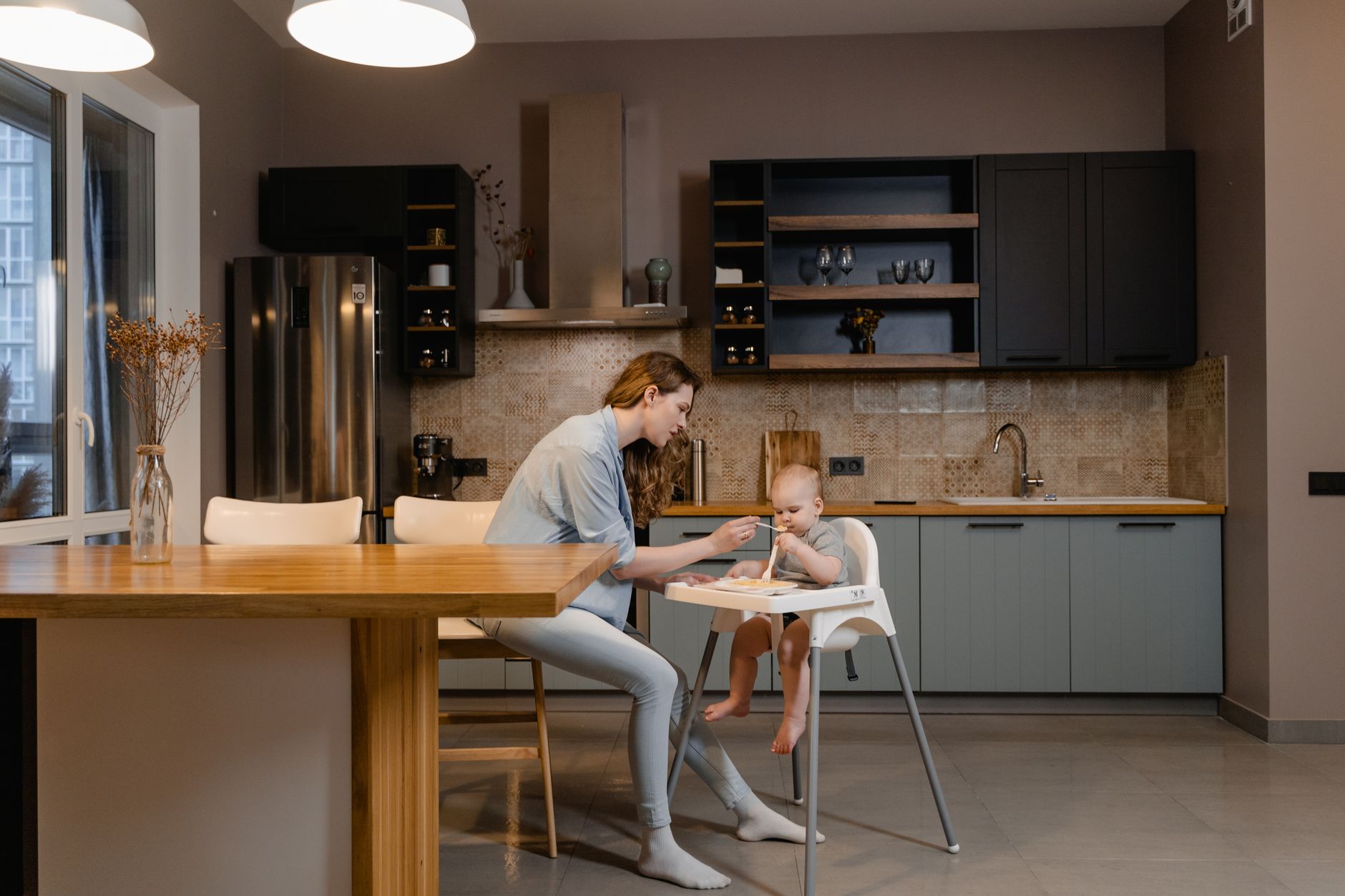 Two Women Sitting on Chair in Front of Table