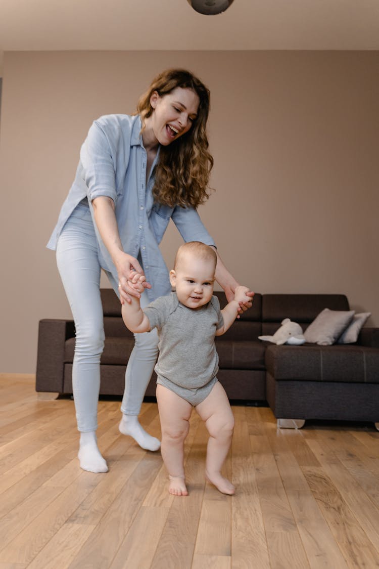 A Mother Walking With Her Baby