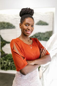Confident businesswoman posing in an elegant office setting with a creative backdrop.