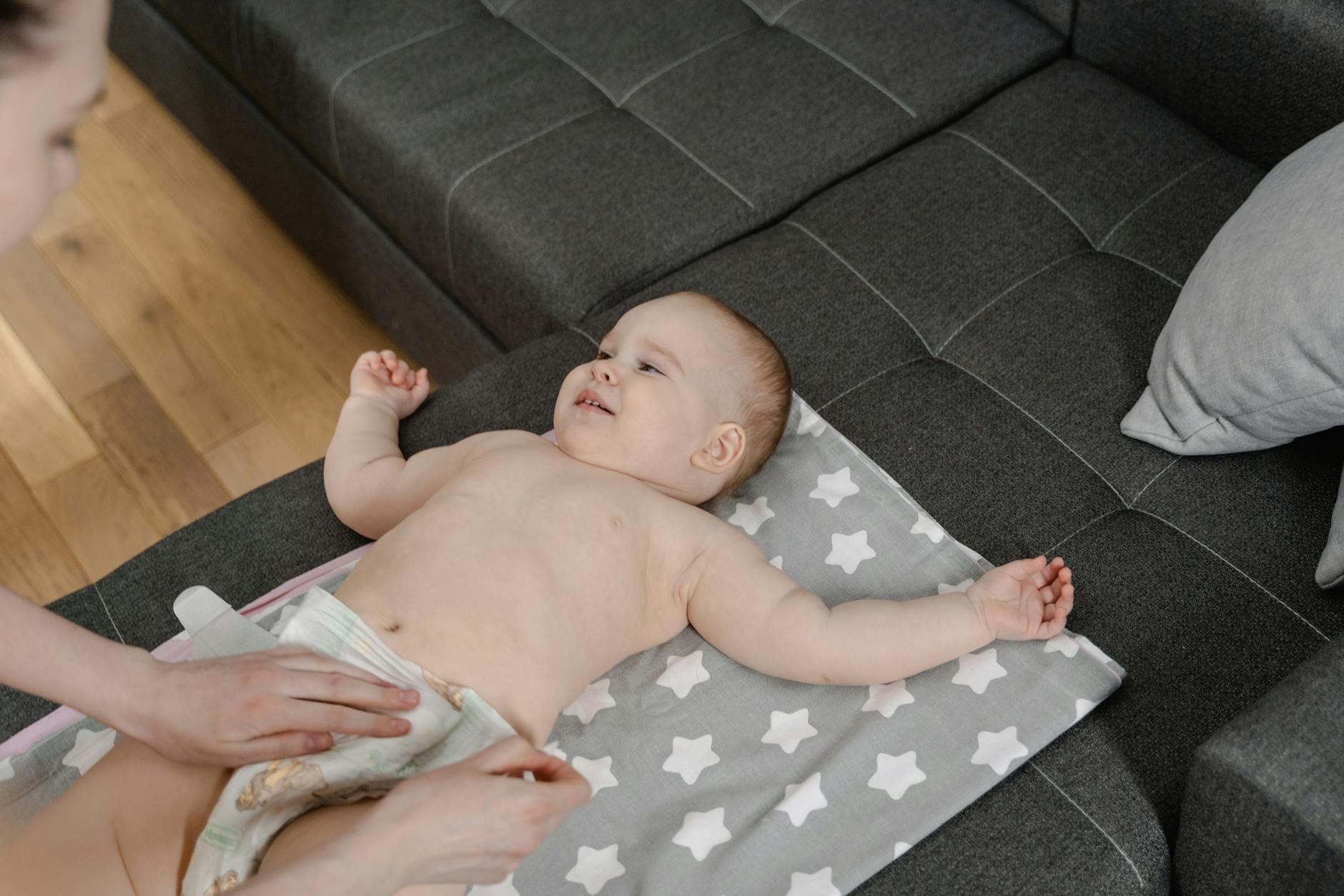 https://www.pexels.com/photo/baby-lying-on-white-textile-7491717/