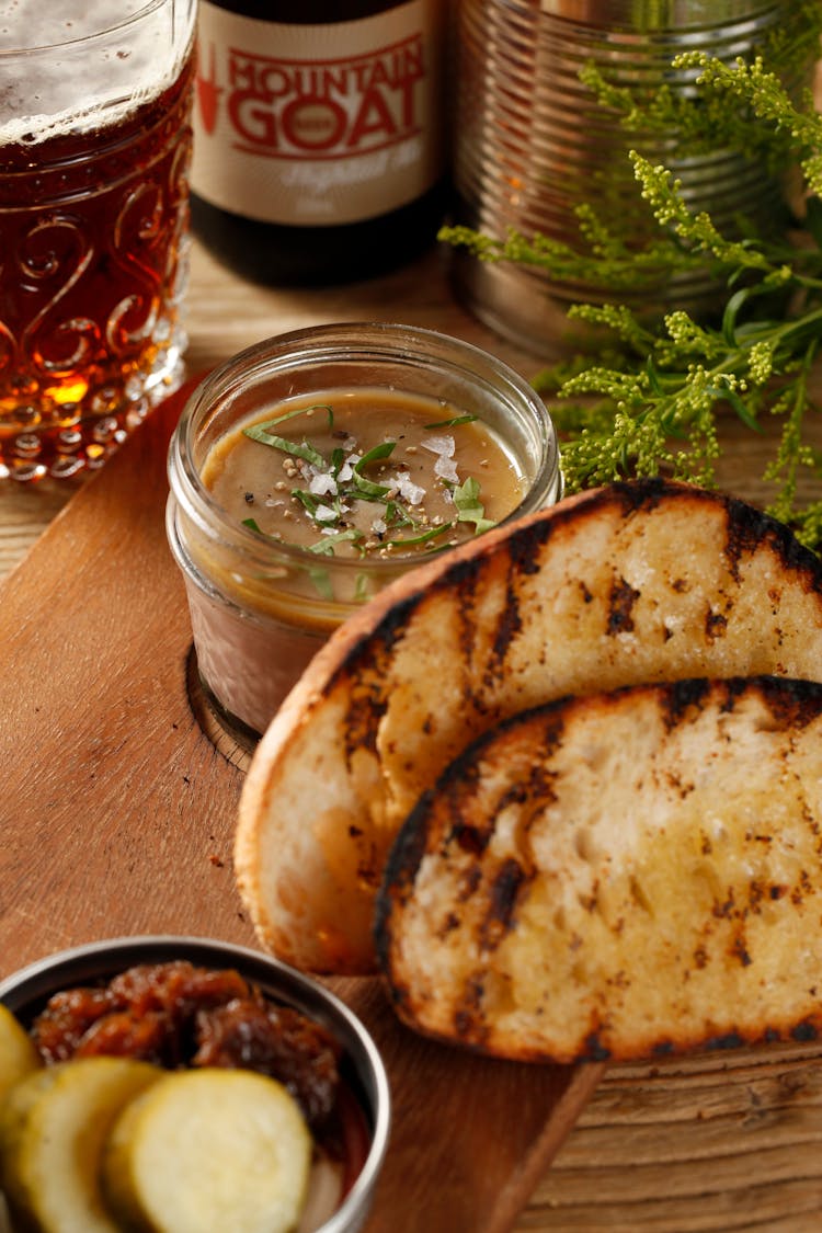 Photograph Of Toasted Bread Near Brown Gravy