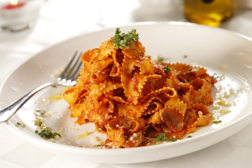 Pasta Dish With Parsley on White Ceramic Plate