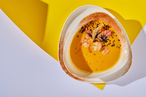 Pumpkin Soup with Shrimps in Ceramic Bowl 