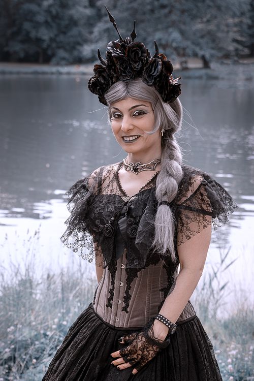 Free Gothic-inspired cosplay with lace and floral accents by a serene lakeside. Stock Photo